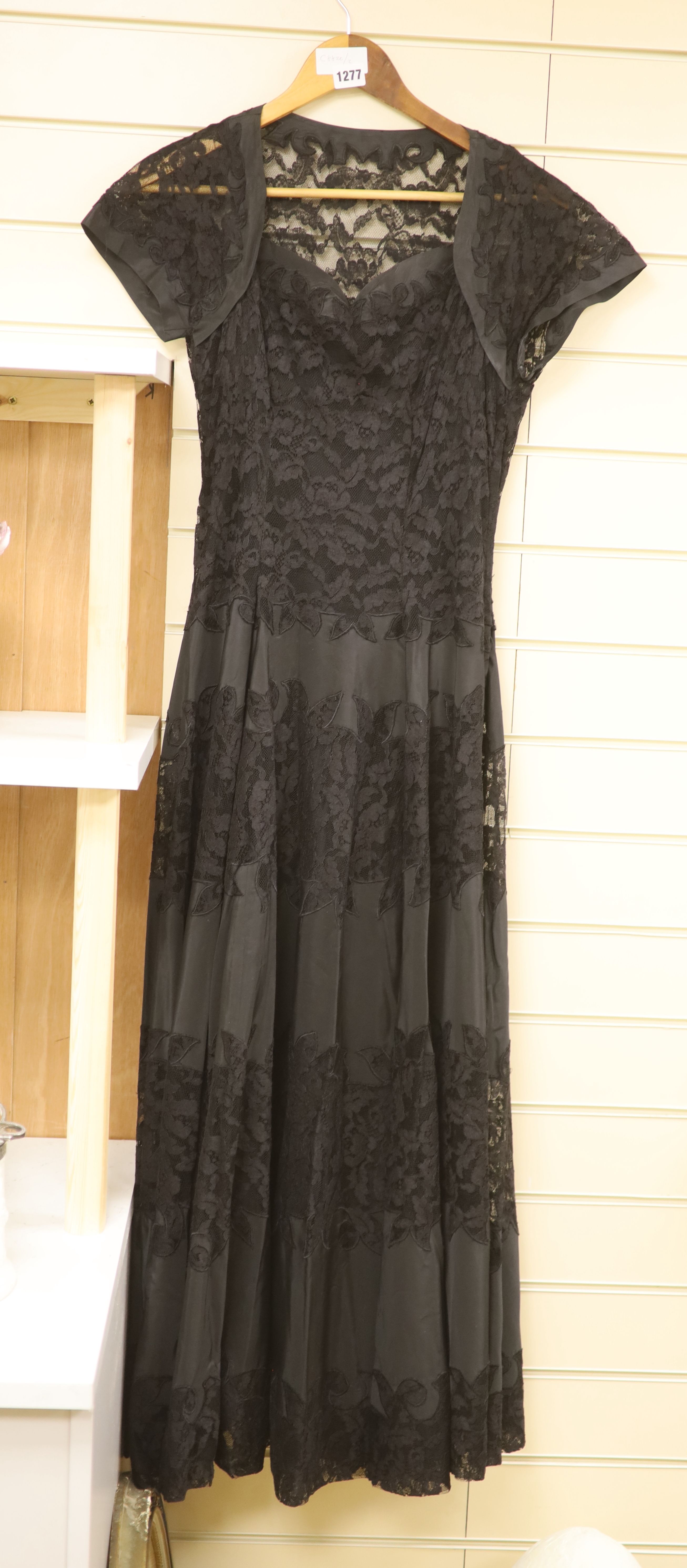 A 1950s black taffeta and lace evening dress